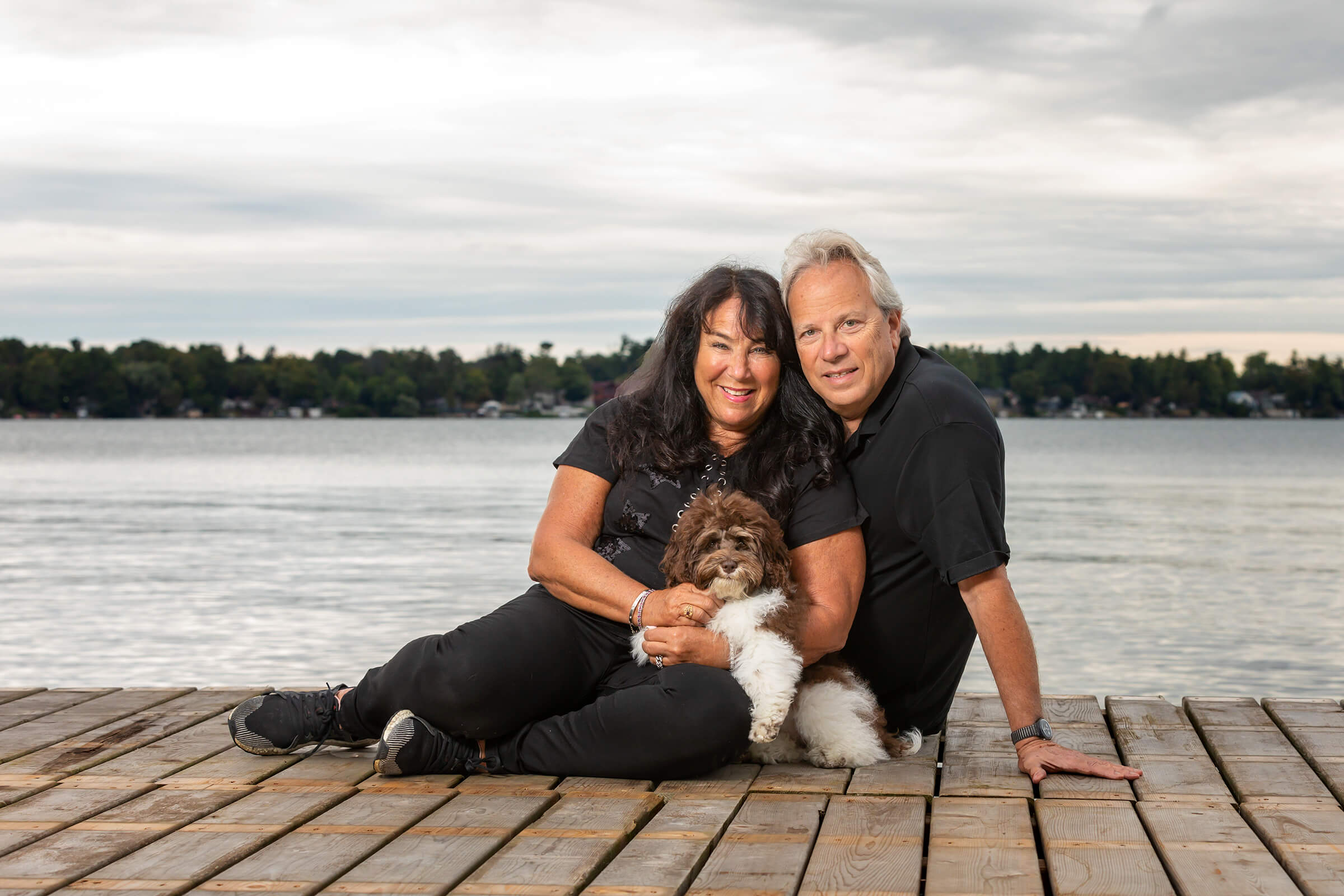 couple with puppy at lake in muskoka