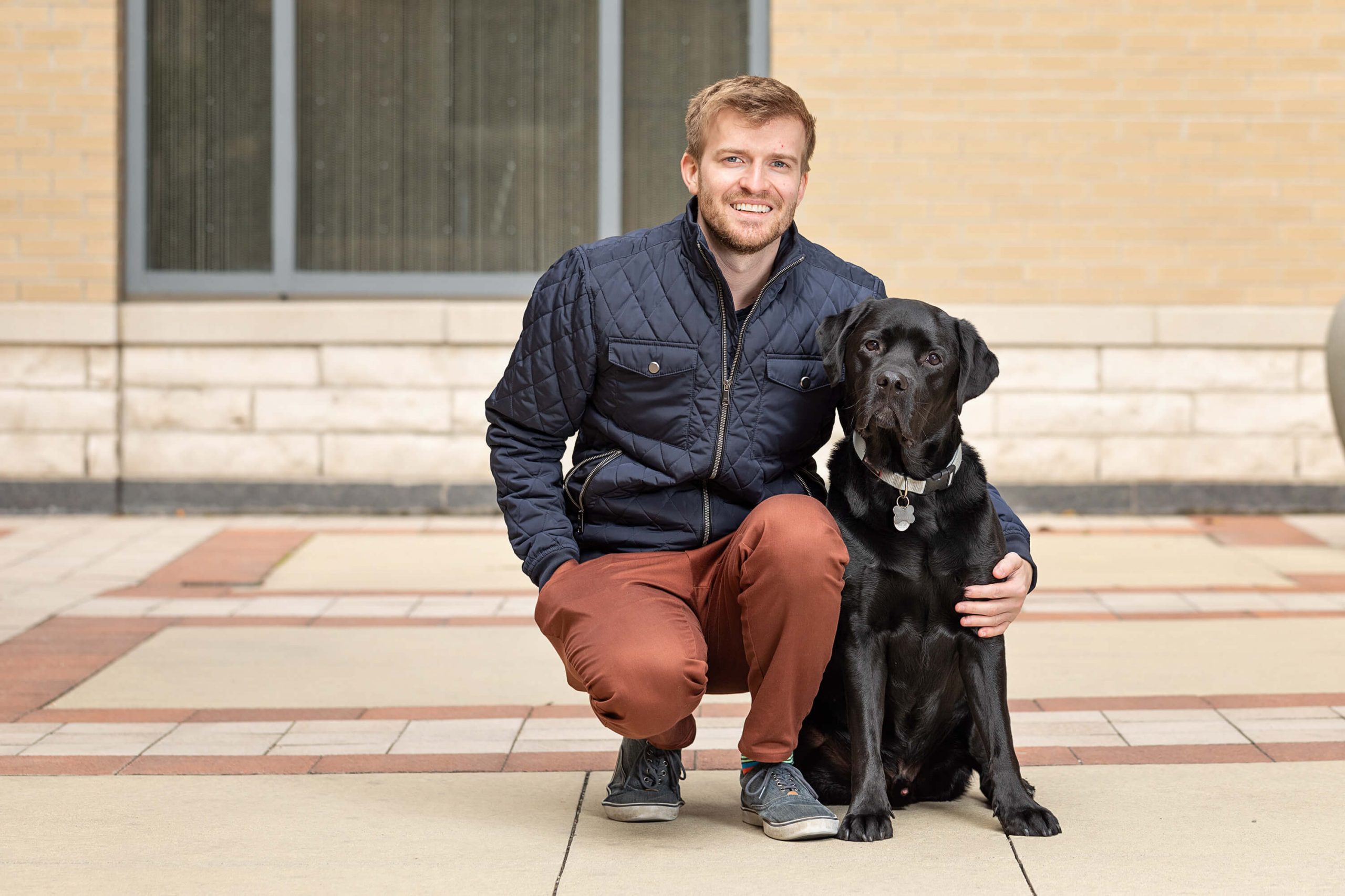 black lab and person in conference room